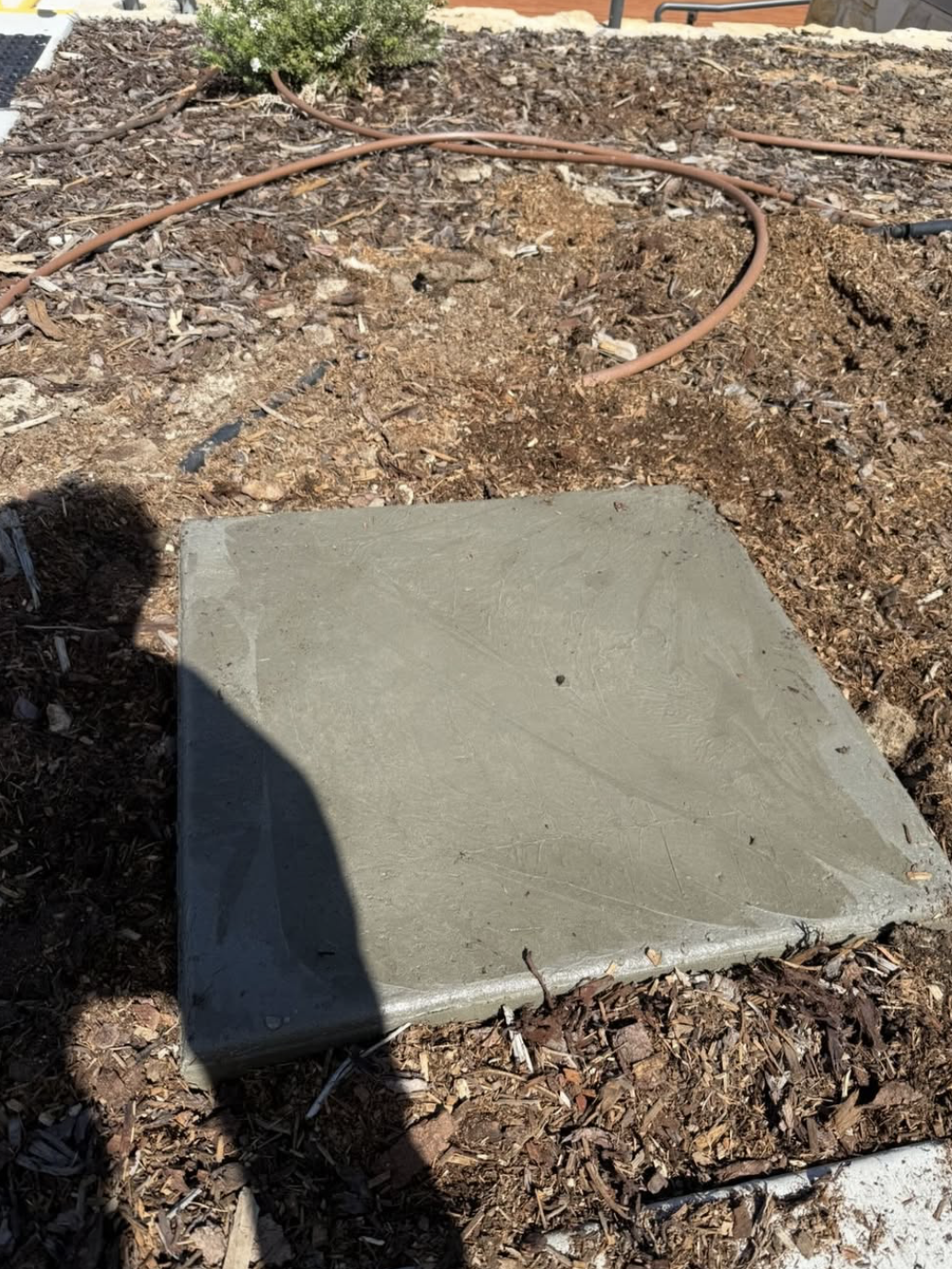 Poured and finished pad set into the garden bed