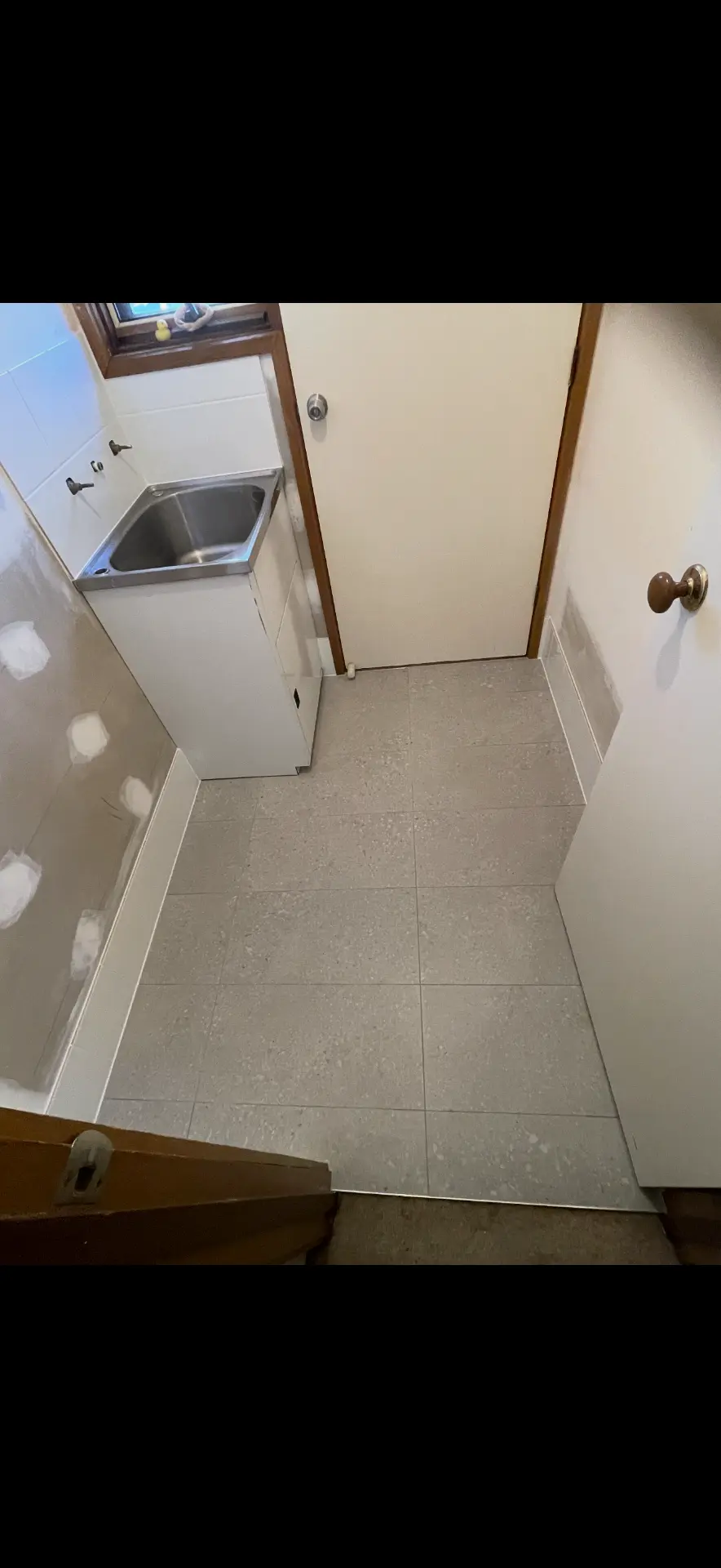 New tiling and tub installed for a clean, finished laundry